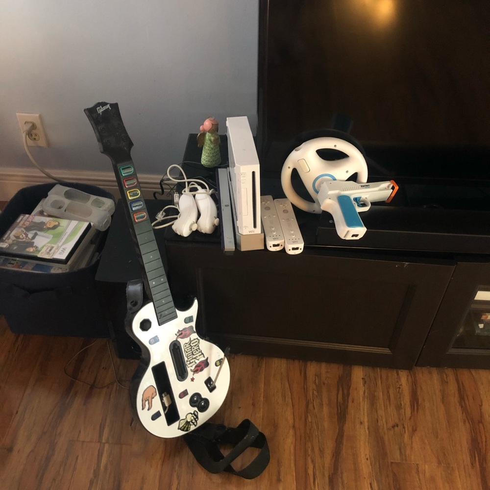 Wii console with 31 games and guitar hero.